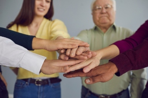 elderly and youths hands in