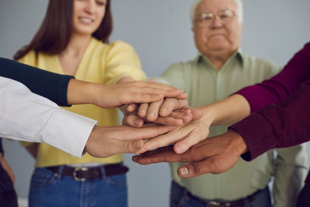 elderly and youths hands in