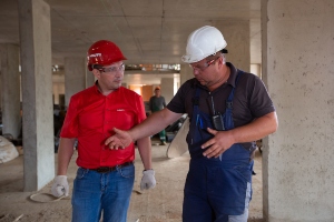 worker explaining safety rules to his colleague